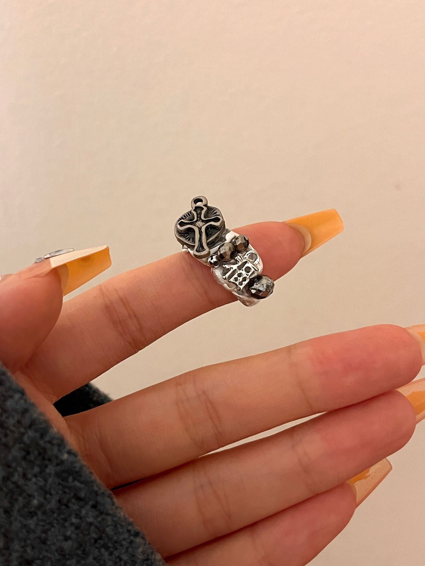 Cross opening ring with tassel pendant
