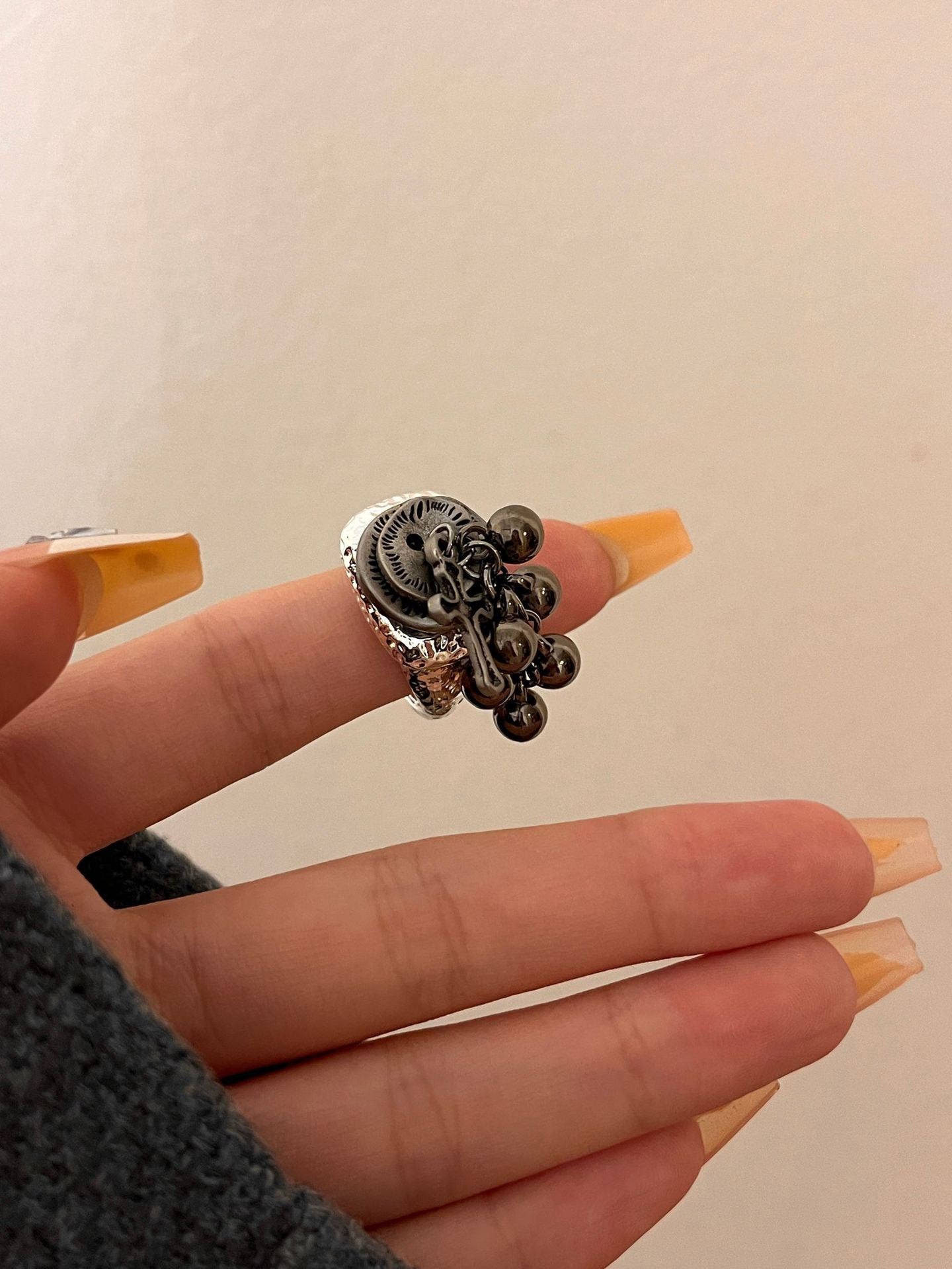 Cross opening ring with tassel pendant